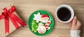 Merry Christmas with woman hand holding coffee cup and homemade cookie on table. Xmas eve, party, holiday and happy New Year Royalty Free Stock Photo