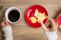 Merry Christmas with woman hand holding coffee cup and homemade cookie on table. Xmas eve, party, holiday and happy New Year Royalty Free Stock Photo