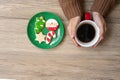 Merry Christmas with woman hand holding coffee cup and homemade cookie on table. Xmas eve, party, holiday and happy New Year Royalty Free Stock Photo