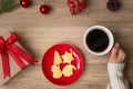 Merry Christmas with woman hand holding coffee cup and homemade cookie on table. Xmas eve, party, holiday and happy New Year Royalty Free Stock Photo