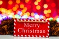 Merry Christmas wooden sign. Christmas composition on blurred lights background Royalty Free Stock Photo