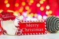 Merry Christmas wooden sign. Christmas composition on blurred lights background. Colorful Christmas balls Royalty Free Stock Photo