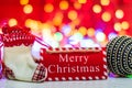 Merry Christmas wooden sign. Christmas composition on blurred lights background. Colorful Christmas balls Royalty Free Stock Photo