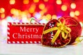 Merry Christmas wooden sign. Christmas composition on blurred lights background. Colorful Christmas balls Royalty Free Stock Photo