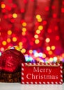Merry Christmas wooden sign. Christmas composition on blurred lights background. Colorful Christmas balls Royalty Free Stock Photo