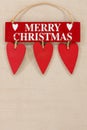 Merry Christmas wooden sign on a pale textured background with space for copy Royalty Free Stock Photo