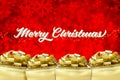 Merry christmas word with Golden present box with big bow at red Royalty Free Stock Photo