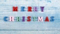 MERRY CHRISTMAS word on wooden background composed from colorful abc alphabet block wooden letters, copy space for ad text. Royalty Free Stock Photo