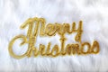 Merry christmas written in gold on white fur Royalty Free Stock Photo