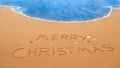 Merry christmas written in the sand