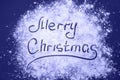 Merry Christmas Written on the Scattered Flour Snow Simulation colored in trendy color of year 2022 Very Peri. Royalty Free Stock Photo