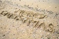 Merry Christmas written on tropical beach sand, copy space. Royalty Free Stock Photo
