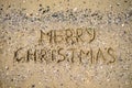 Merry Christmas written on tropical beach sand, copy space. Royalty Free Stock Photo