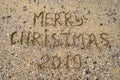 Merry Christmas written on tropical beach sand, copy space. Holiday concept, top view Royalty Free Stock Photo