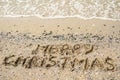 Merry Christmas written on tropical beach sand, copy space. Royalty Free Stock Photo