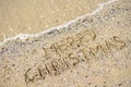 Merry Christmas written on tropical beach sand, copy space. Royalty Free Stock Photo