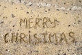 Merry Christmas written on tropical beach sand, copy space. Holiday concept, top view Royalty Free Stock Photo