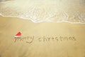 Merry Christmas written on tropical beach white sand Royalty Free Stock Photo