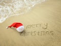 Merry Christmas written on tropical beach white sand with snowman Royalty Free Stock Photo