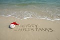Merry Christmas written on tropical beach white sand Royalty Free Stock Photo