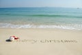 Merry Christmas written on tropical beach white sand Royalty Free Stock Photo