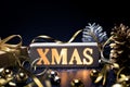 Merry christmas,xmas and celebration concepts with xmas lightbox text and ornament in golden color on dark