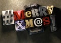 Merry Christmas Xmas title in vintage wood block text and hashtag