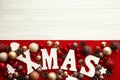 Merry Christmas. Xmas wooden word with red and gold baubles orna Royalty Free Stock Photo