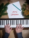 Young hands of a girl playing on a keyboard with Christmas decor Royalty Free Stock Photo