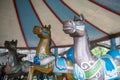 Merry-go-round horses or carousel in funfair or amusement park