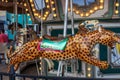 A Merry-go-round with horses and cheetahs with colorful lights and carnival rides along the boardwalk at the Carolina Beach Royalty Free Stock Photo