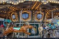 A Merry-go-round with horses and cheetahs with colorful lights and carnival rides along the boardwalk Royalty Free Stock Photo