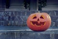 Merry Halloween pumpkin with a carved face. An unusual ominous smile.