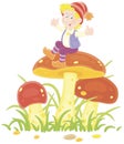 Merry little boy sitting on a big mushroom