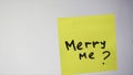 Merry me is an inscription on a piece of paper. Inscription on the sticker merry me on a white background