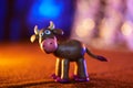 Merry plasticine cow from Christmas series and blurred lights