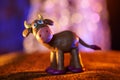 Merry plasticine cow from Christmas series and blurred lights