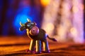 Merry plasticine cow from Christmas series and blurred lights