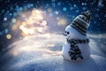 Merry snowman standing in a winter night Christmas landscape. Merry Christmas and Happy New Year Greeting Card Royalty Free Stock Photo