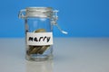 Merry word on piggy Bank, moneybox, money jar with coins Royalty Free Stock Photo