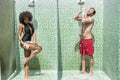 Merry young couple taking hygienic procedures after swimming