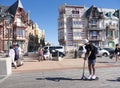 Boulevard with people and colorful houses of mers les bains in french normandy
