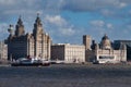The Mersey Ferry Royal Iris passes the Three Graces on Liverpool`s historic, UNESCO listed waterfront on a sunny day