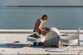 Mersin, Mezitli / Turkey - 11 15 2010: Unknown sculptor carves sculpture from white marble with grinding tool. Sea in the