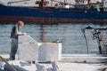 Mersin, Mezitli / Turkey - 11 15 2010: Unknown sculptor carves sculpture from white marble. Ship and sea in background