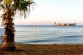 Mersin, Turkey - August 16, 2019: Maiden`s castle, Kiz Kalesi with palm in Mediterranean Sea. Mersin Turkey Royalty Free Stock Photo