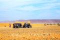 Merzouga, Morocco - Feb 26, 2016: back view on group of off-road pilots during a break in berber village on Morocco desert near M