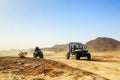 Merzouga, Morocco - Feb 24, 2016: convoy of off-road vehicles (RZR, Quad and motorbikes) in Morocco desert near