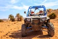 Merzouga, Morocco - Feb 26, 2016: front view on blue Polaris RZR 800 with it's pilots in Morocco desert near Merzouga. Merzouga is