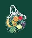 Mesh eco bag full of fruit and vegetables (grape, orange, apple, banana, broccoli, avocado). Fresh organic food Royalty Free Stock Photo